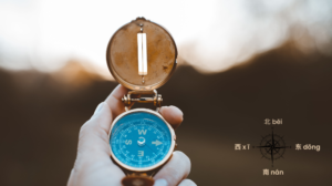 Freepick "Closeup shot of a person holding a compass with a burred background" by wirestock