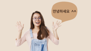 Freepick "Friendly joyful young cute female brunette glasses denim overalls raising both palms waving saying hi greeting making hello gesture smiling broadly every guest gray wall" by cookie_studio