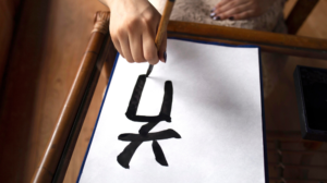 Freepik Assets "Free photo asian woman practicing japanese handwriting indoors"