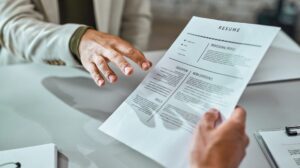 Freepik "Free photo closeup of a candidate giving his cv while applying for a job in the office" by Drazen Zigic