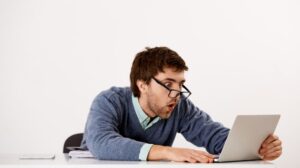 Freepik "Free photo shocked, startled and impressed office worker, male entrepreneur sitting desk, staring" by cookie_studio