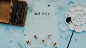 Freepik Assets "Free photo wooden typographic blocks; feather; march blocks and march stamp on calendar"